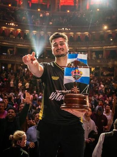 Esports champion with the Red Bull ship trophy in a packed concert hall